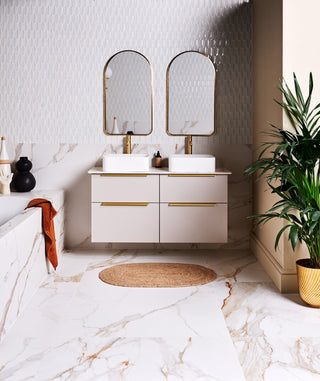 A modern bathroom with marble floor tiles and decorative wall tiles