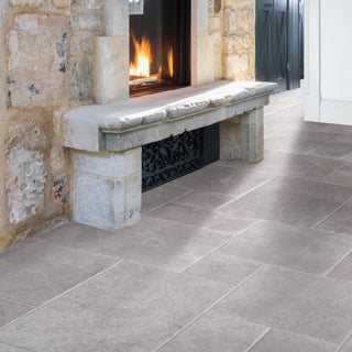 stone floor with a bespoke stone bench in front of a fireplace
