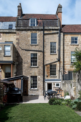 Traditional stone building with a garden in the foreground