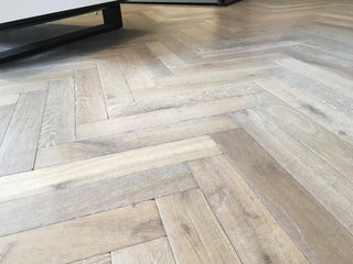 Herringbone wood flooring in a room setting